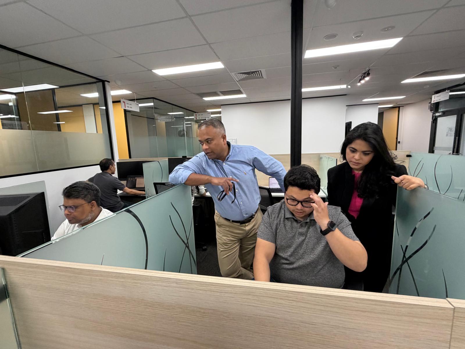 Colleagues collaborating at a shared workstation