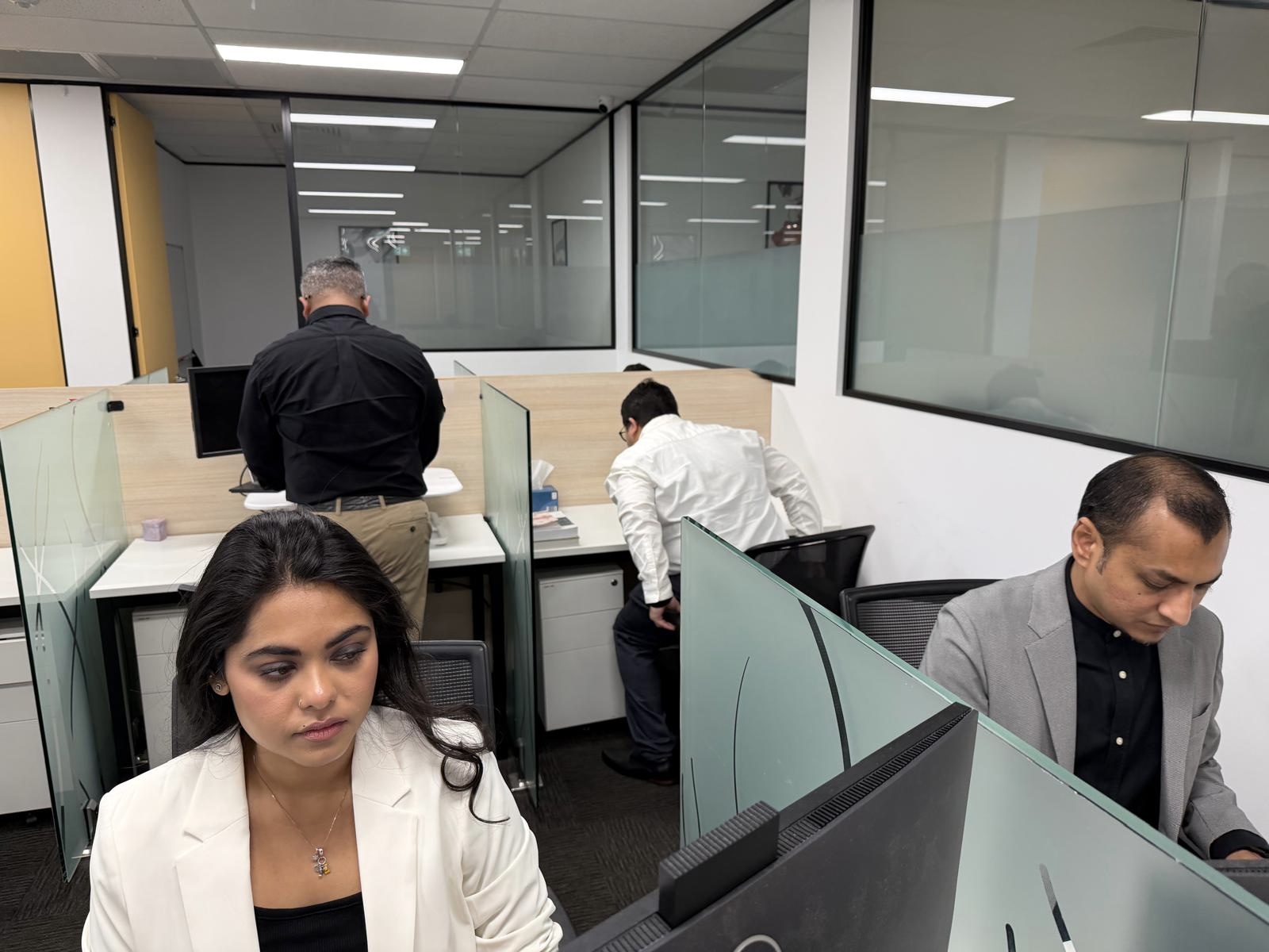Team members reviewing work at their desks
