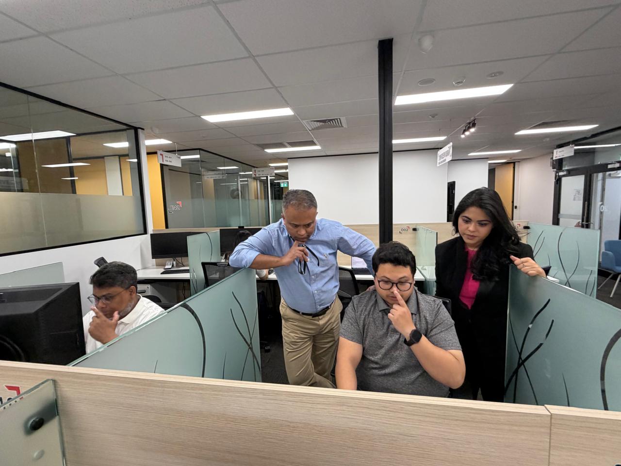 Team discussing findings at a shared workstation